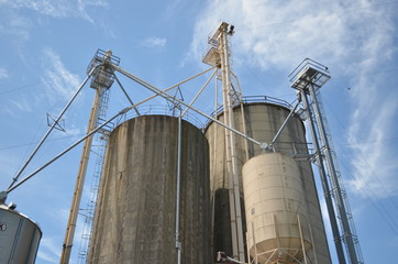Industrial grain silos against blue sky