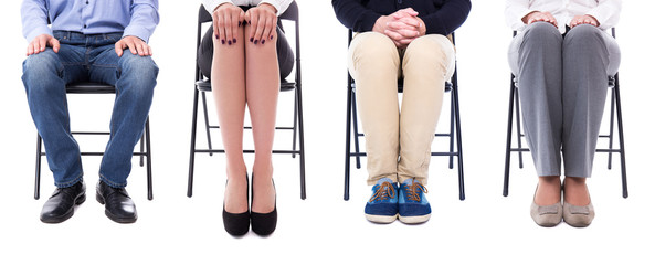career concept - legs of business people sitting on office chair