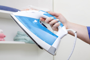 Woman holding an iron