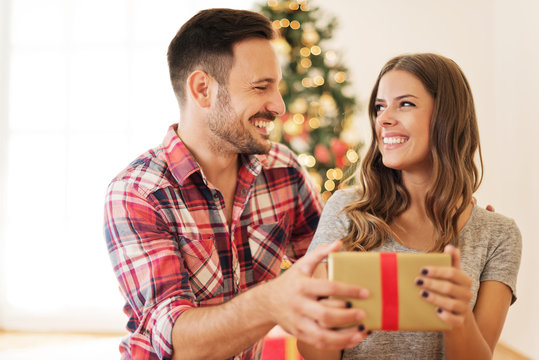 Man giving a Christmas present to his girlfriend
