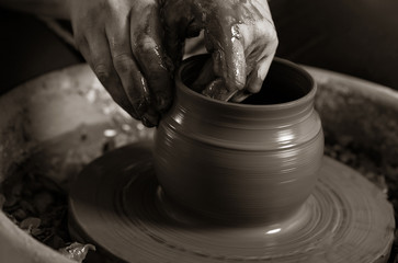 Fototapeta na wymiar Potter shaping clay on the pottery wheel