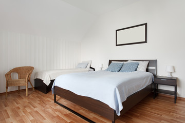 Fototapeta na wymiar Small bedroom with two beds