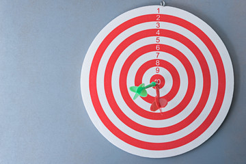 red and green darts on dartboard