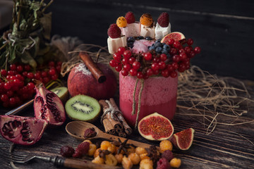 Fresh smoothie on wooden table in the glass
