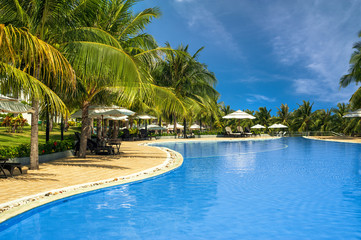 Fototapeta na wymiar Swimming pool in amazing tropical luxury hotel. Mui Ne, Vietnam travel destinations