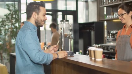 Handsome Young Man Paying for Takeaway Coffee with Credit Card at Coffee Shop. Shot on RED Cinema Camera in 4K (UHD).