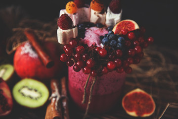 Fresh smoothie on wooden table in the glass
