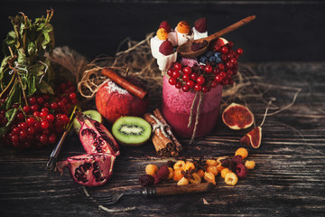 Fresh smoothie on wooden table in the glass
