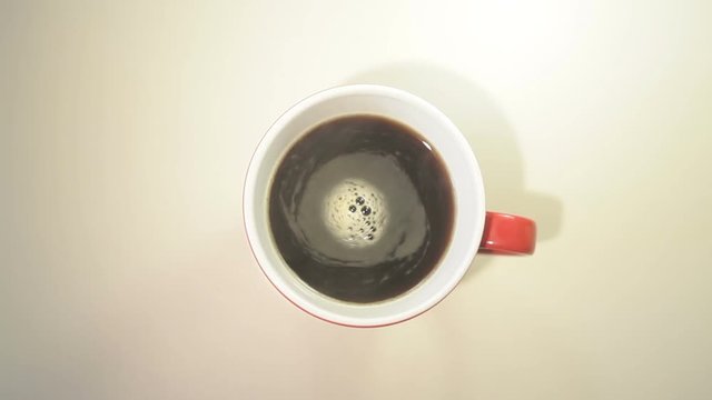 Cup with hot black coffee over white background