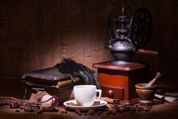 Cup of coffee, dry rose and grinder