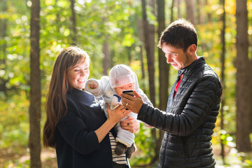 Portrait of a happy young couple playing with their cute newborn baby