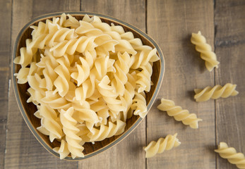 Fusilli pasta in wooden bowl