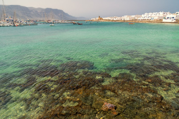 A small marina and a beach on the island of La Graciosa.