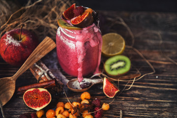 Fresh smoothie on wooden table in the glass