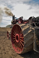 Amish steam tractor engine plowing the field