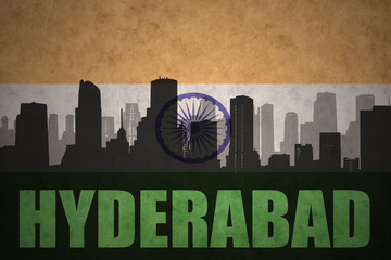 abstract silhouette of the city with text Hyderabad at the vintage indian flag background