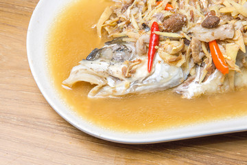 Chinese style marinated steamed fish with Onion and ginger..