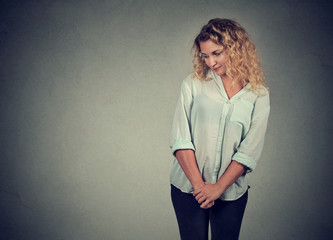 Shy insecure young woman looking down