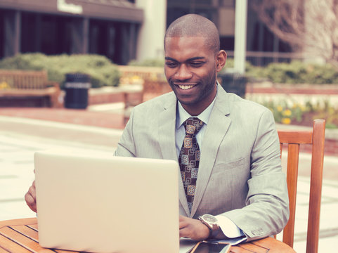 businessman working on his laptop outdoors corporate office