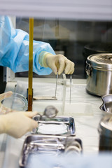 Scientists in protective suits in the 