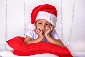 A small child dressed as Santa Claus in anticipation of Christmas and New Year