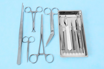 Flat lay of medical instruments on blue background