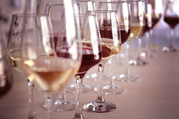 Glasses with red and white wine on table in restaurant