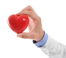 Fototapeta premium Male doctor holding red heart on white background