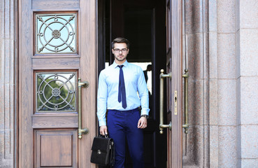 Handsome young lawyer  leaving building