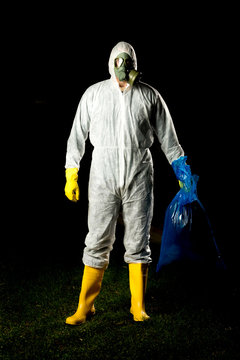 man in bio hazard protective suit with gas mask and gloves