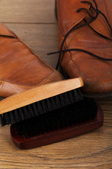 Fototapeta na wymiar Shoes and cleaning equipment on a wooden floor