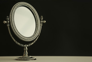 Female mirror on dark background