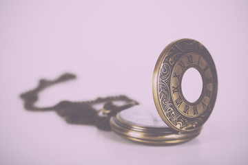 Pocket watch against a light background Vintage Retro Filter.