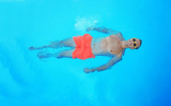 Handsome Man Relaxing In Swimming Pool