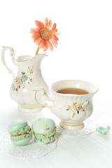 Afternoon tea with macaroons and gerber flower still life