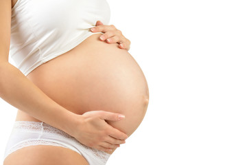 Close up of a cute pregnant belly isolated on white. Pregnancy concept.
