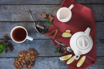 Fresh tea composition on napkin on wooden background