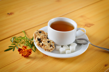 Breakfast still life. Cup of tea and marigolds