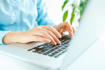 Woman office worker typing on the keyboard