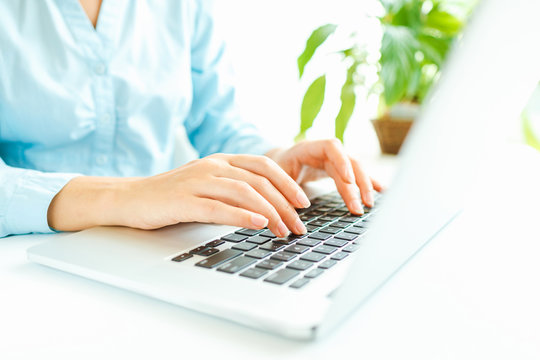 Woman office worker typing on the keyboard