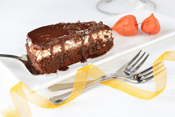 Piece of tasty chocolate cake with black chocolate sauce
