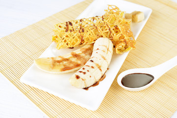 delicious pancakes with banana and chocolate syrup on it