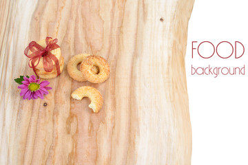 Food background. Nice cookies on wooden backdrop with ribbon and flower.