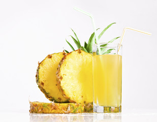 Fresh pineapple juice with sliced pineapple on white background