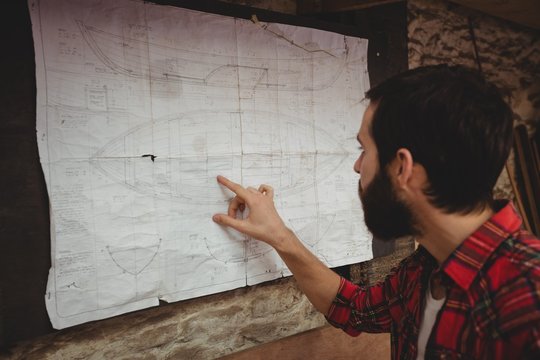 Man looking at blueprint
