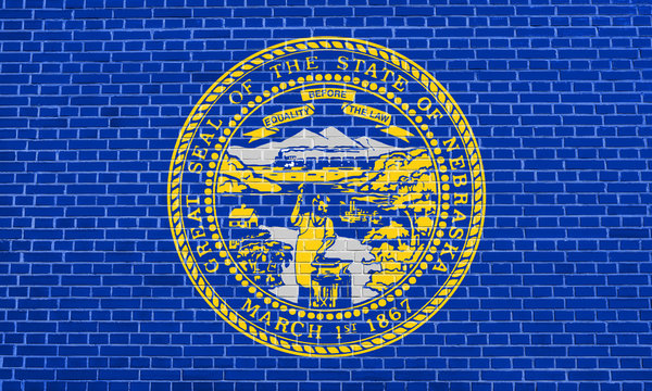 Flag of Nebraska on brick wall texture background