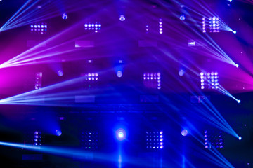 Stage lights of different colors, background of glowing blue and red spotlights