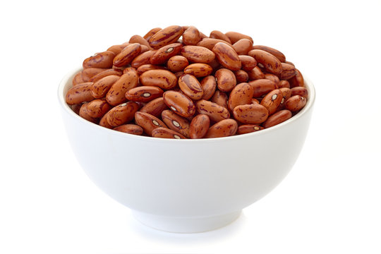 Bowl with pinto beans on white