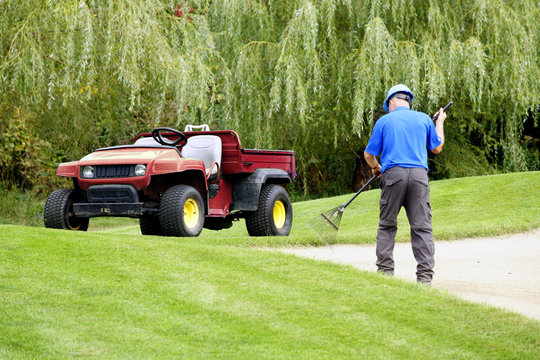 Grounds keeper working on a golf course