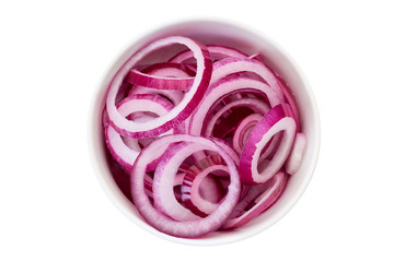 Sliced red onion in bowl on white.
